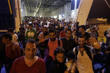 Migrants disembark from the catamaran Terra Jet at the Athens' port of Piraeus, on Tuesday, Sept. 1, 2015.  AP