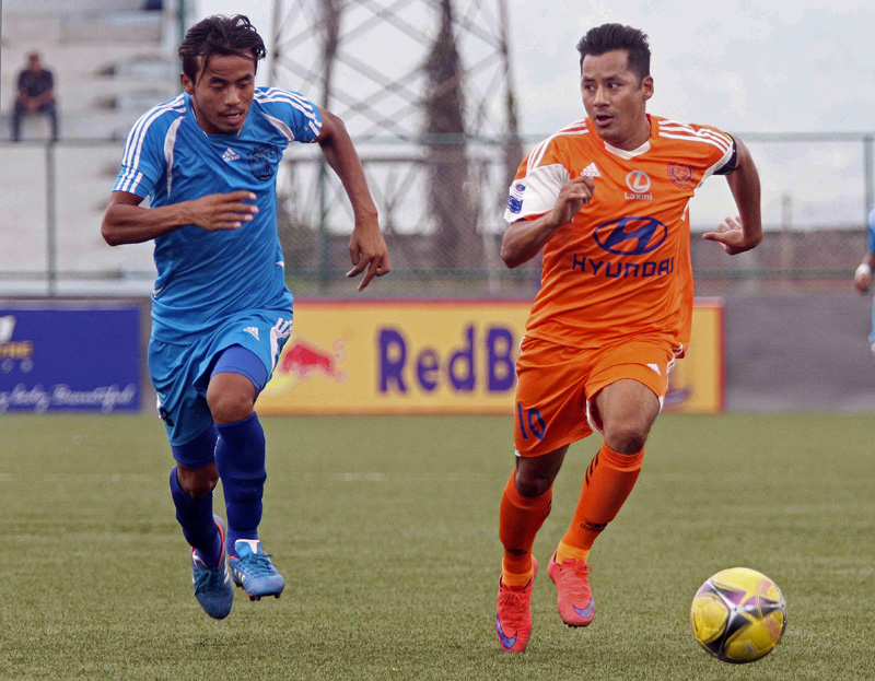 Anil Gurung (right) skipper of Manang Marsyangdi Club dribbles the ball against Dinesh Rajbansi of Far Western Football Club during their Red Bull National League match at ANFA Complex in Lalitpur on Thursday. Courtesy:Udipt Singh Chhetry)
