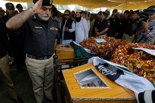 Police chief Nasir Khan Durrani salutes to police officers killed in an attack in Peshawar, Pakistan, Wednesday, Sept. 2, 2015. Photo: AP