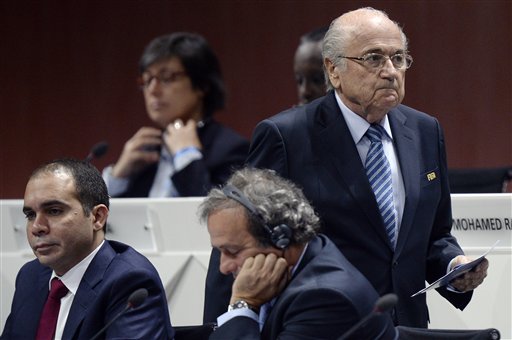FILE - In this May 29, 2015 file photo FIFA president Joseph S. Blatter, right, walks past Prince Ali bin al-Hussein, left, and UEFA President Michel Platini, center, during the 65th FIFA Congress held at the Hallenstadion in Zurich, Switzerland. On Friday, Sept. 25, 2015 Swiss attorney general opened criminal proceedings against FIFA President Sepp Blatter.  (Walter Bieri/Keystone via AP)
