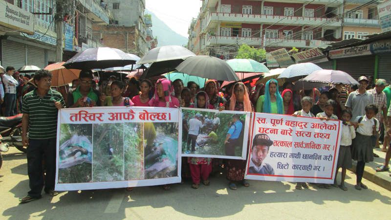 Relatives of Purna Bahadur Ale, who was allegedly murdered, staging a rally demanding stern action against the murderer in Damauli, Tanahun, on Friday.  Photo: THT