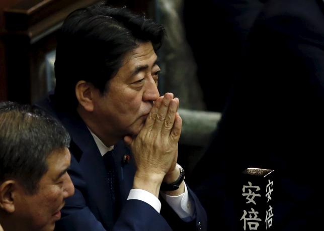 Japan's Prime Minister Shinzo Abe sits next to minister in charge of reviving local economies Shigeru Ishiba (L) during the plenary session for his cabinet's censure motion at at the Lower House of the parliament in Tokyo, Japan, September 18, 2015. REUTERS/Toru Hanai