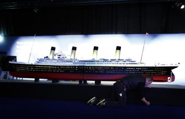 A staff works on a scale model of the Titanic during a media preview of the Titanic exhibition at the Palexpo in Geneva October 9, 2014.   REUTERS/Denis Balibouse/Files