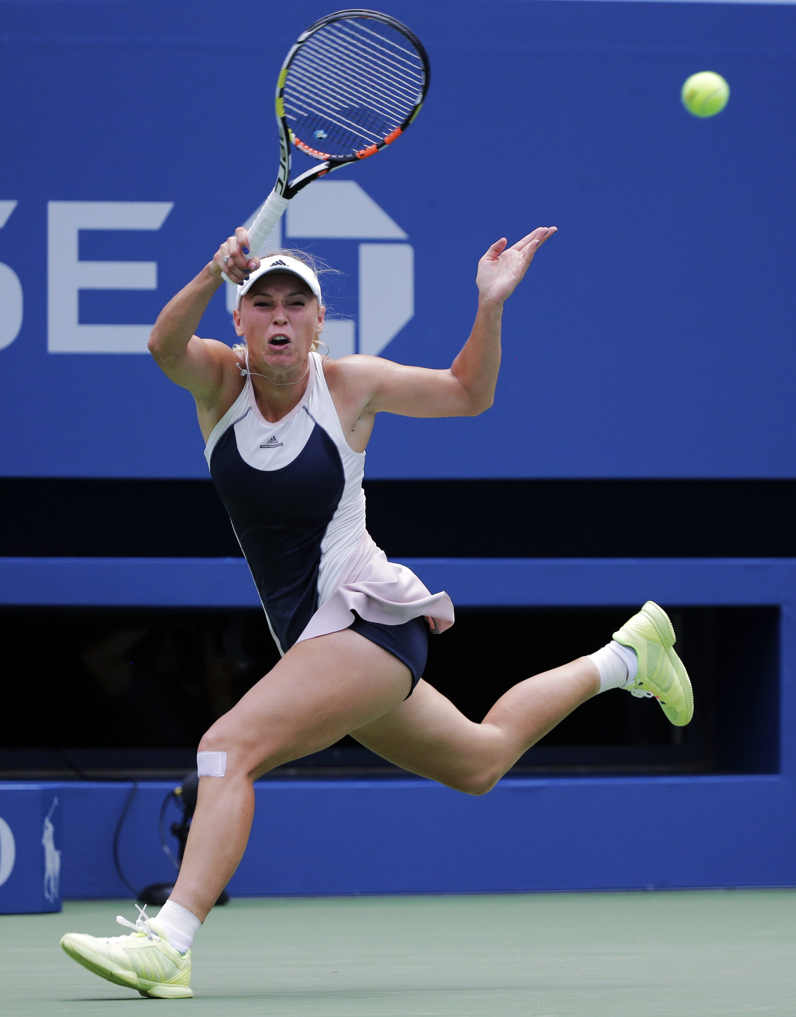 Caroline Wozniacki, of Denmark, returns a shot to Jamie Loeb, of the United States, during the first round of the US Open tennis tournament, Tuesday, Sept. 1, 2015, in New York. PHOTO: AFP