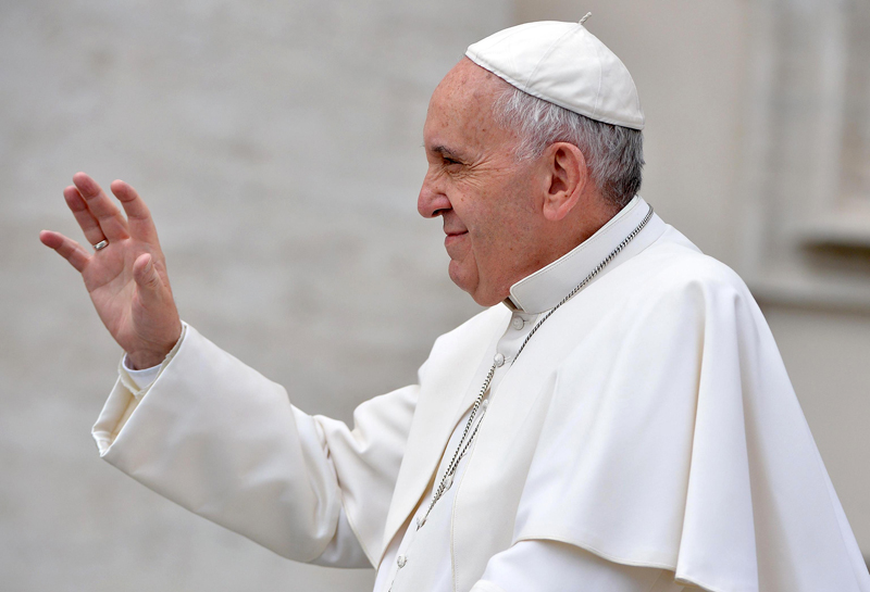 Pope Francis waves to faithful as he arrives for his weekly general audience in St. Peter's Square, at the Vatican, Wednesday, Sept. 30, 2015. (Maurizio Brambatti/ANSA via AP)