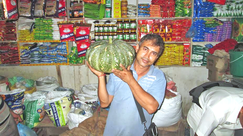 A vegetable trader Bijay Raj Paudel displaying a 12-kg pumpkin produced by Jhilke Chepang of Sur VDC in Tanahun district, on Saturday, September 05, 2015. Photo: Madan Wagle