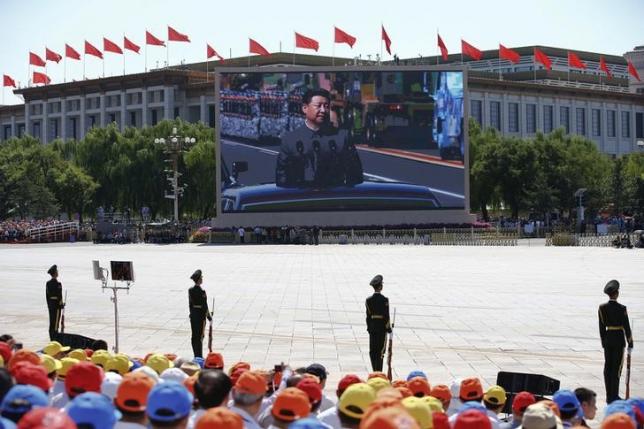 Chinese President Xi Jinping is shown on a big screen at Tiananmen Square as he reviews troops at the beginning of the military parade marking the 70th anniversary of the end of World War Two, in Beijing, China, September 3, 2015 REUTERS/Damir Sagolj