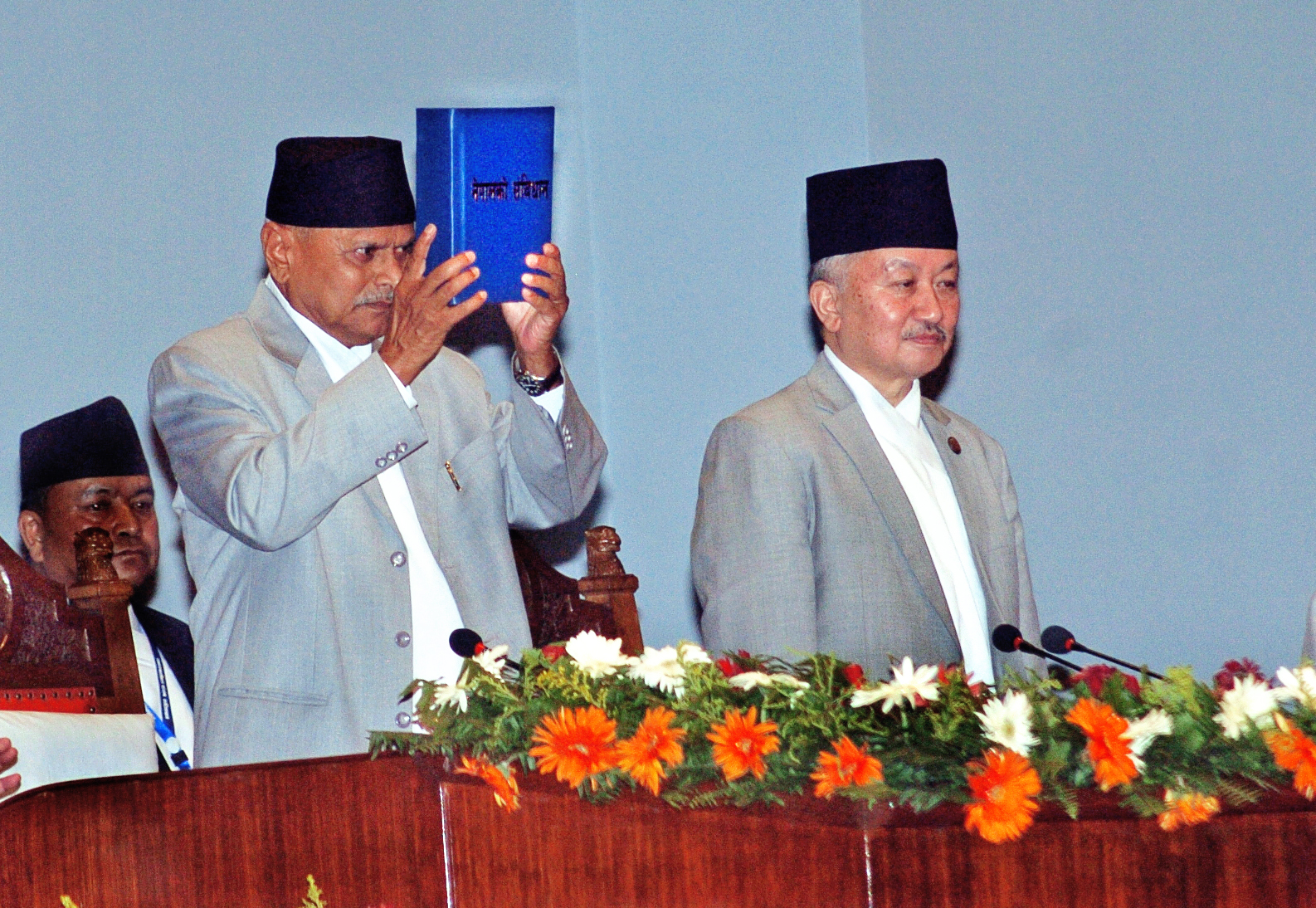 The then President Ram Baran Yadav promulgating Nepalu2019s  Constitution after signing the copies of the constitution authenticated by CA Chairman Subas Chandra Nembang during a special function at the Constituent Assembly Hall on Sunday. Photo: Dhruba Ale/ THT