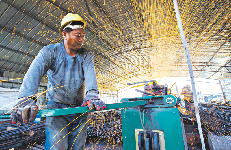 A labourer cuts steel bars at a railway bridge construction site in Lianyungang, Jiangsu province, China, September 12, 2015. Growth in China's investment and factory output missed forecasts in August, pointing to a further cooling in the world's second-largest economy that will likely prompt the government to roll out more support measures. Picture taken September 12, 2015. REUTERS/China Daily CHINA OUT. NO COMMERCIAL OR EDITORIAL SALES IN CHINA      TPX IMAGES OF THE DAY
