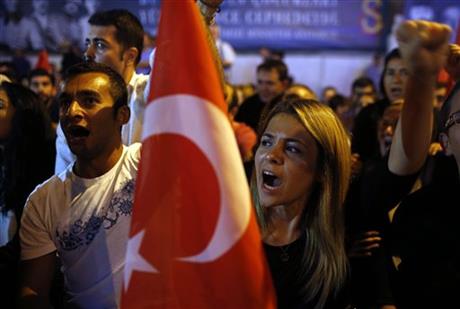 People stage a protest to condemn terrorism in Istanbul, Turkey, Monday, Sept. 7, 2015, a day after Turkey's military announced Monday that 16 soldiers were killed and six others were wounded in a Kurdish rebel attack against troops in southeast Turkey on Sunday.  AP