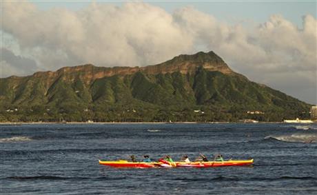 A outrigger canoe paddles past Diamond Head mountain, Wed. Sept. 16, 2015 in Honolulu. A powerful magnitude-8.3 earthquake hit off Chile's northern coast Wednesday night putting Hawaii under a tsunami advisory. AP