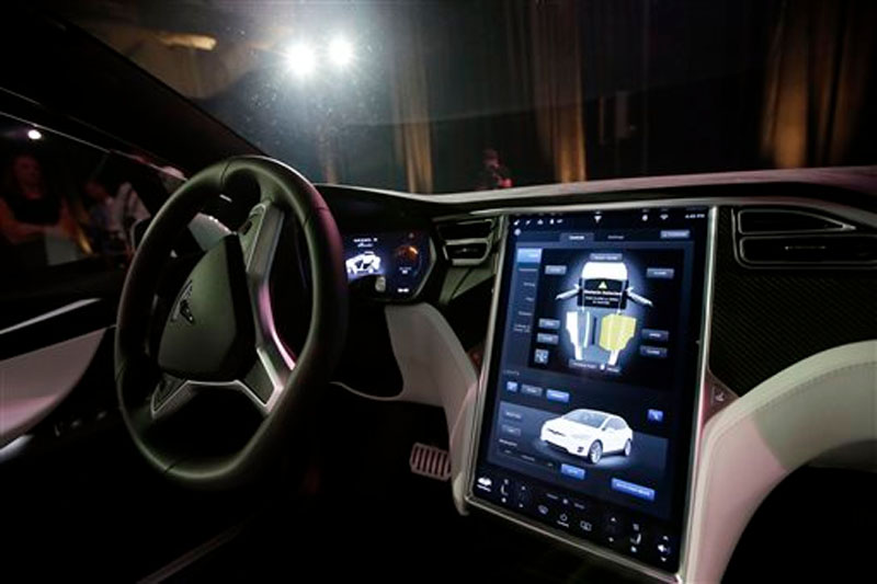 The dashboard of the Tesla Model X car is shown at the company's headquarters on Tuesday, September 29, 2015, in Fremont, Calif.  Model X sets a new bar for automotive engineering, with unique features like rear falcon-wing doors, which open upward, and a driveru2019s door that opens on approach and closes itself when the driver is inside. Photo: APn