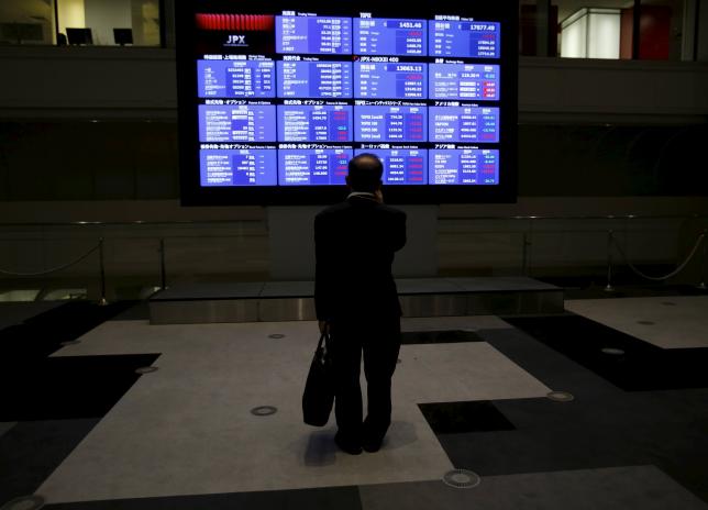 A man looks at an electronic board showing Japan's Nikkei average and related indices at the Tokyo Stock Exchange (TSE) in Tokyo August 26, 2015.  REUTERS/Yuya Shino