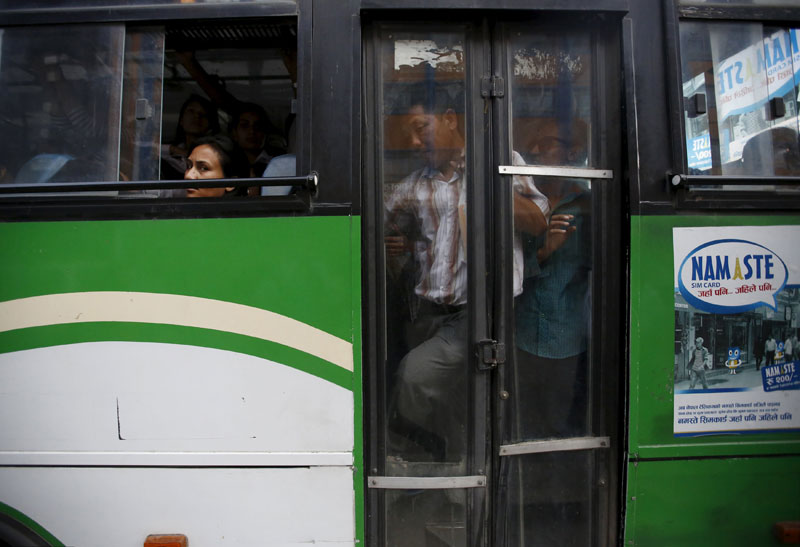 Passengers ride in an overcrowded bus as limited public transportation operates in the city during an ongoing oil and fuel crisis in Kathmandu, Nepal September 29, 2015. Tension between Nepal and India has spiked since Nepal adopted a new constitution last week, upsetting southern minority groups who fear being marginalised in a new federal structure. Indian oil trucks stopped crossing into Nepal because of protests in the south, prompting authorities to try to limit the use of cars and save fuel.  Photo: Reuters