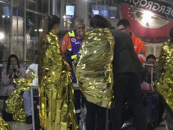 Passengers wrapped in thermal foil blankets given out by emergency services after their Eurostar train was stranded at Calais Station, after intruders were seen near the Eurotunnel, in Calais, France September 2, 2015. REUTERS/John Pullman