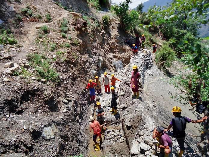 Local people constructing the road under Rural Access Programme (RAP) of the District Development Committee (DDC), in Tola VDC of Bajura district on Tuesday, September 01, 2015. Photo: Prakash Singh