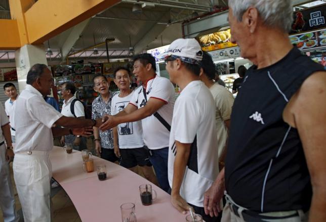 Singapore's Foreign Minister K. Shanmugam of the ruling People's Action Party speaks with residents during a visit to a hawker centre in Singapore September 3, 2015. Photo: REUTERS