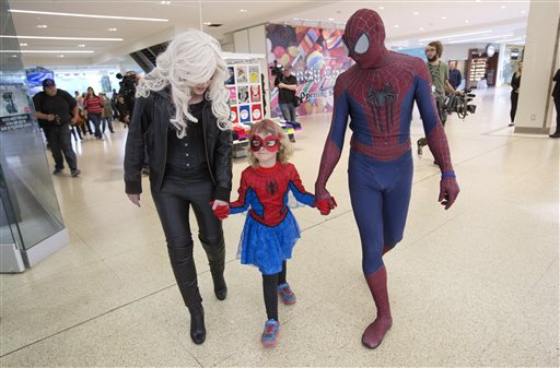 Mable Tooke, aka SpiderMable, walks with Black Cat and Spiderman after rescuing Black Cat in Edmonton, Alberta, on Monday, September 28, 2015. Photo: The Canadian Press via AP