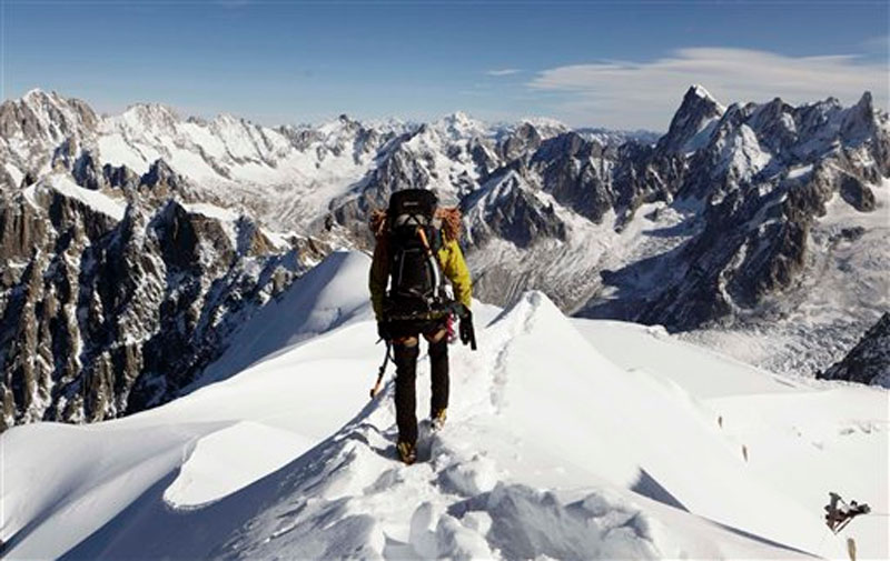 An alpinist heads down a ridge on the Aiguille du Midi (3,842 meters; 12 605 feet), towards the Vallee Blanche on the Mont Blanc massif, in the Alps, near Chamonix, France on Oct. 12, 2011. File photo: AP