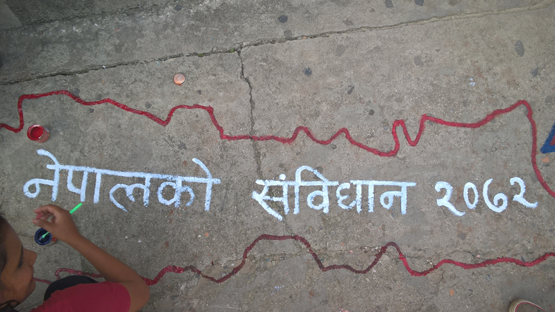 Welcoming Nepal's Constitution 2072 by painting on street pavement on Sunday, September 20, 2015, in Anamnagar, Kathmandu. Photo: Sureis/THT Online