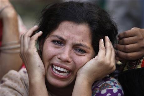 A woman mourns the death of her daughter, a victim of landslide, in Karachi, Pakistan, Tuesday, Oct. 13, 2015. Police say a landslide has hit three makeshift homes in a slum, killing more than a dozen people. Senior police officer Javed Jaskani says the incident took place early Tuesday when a mass of mud and rocks crashed down a hill into camps in Karachi, the capital of southern Sindh province. He says women and children were among the dead and injured. Photo: AP