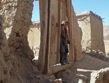 Children stand at the entrance gate to their house after an earthquake, in Farkhar district of Takhar province, Afghanistan October 27, 2015. REUTERS/Stringer