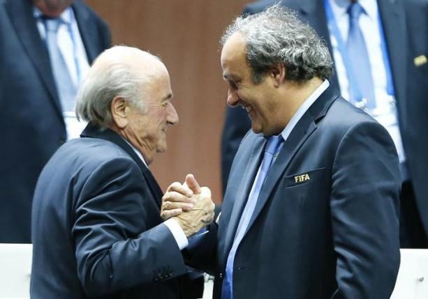 UEFA President Michel Platini (right) congratulates FIFA President Sepp Blatter after he was re-elected at the 65th FIFA Congress in Zurich, Switzerland, May 29, 2015.  Photo: Reuters