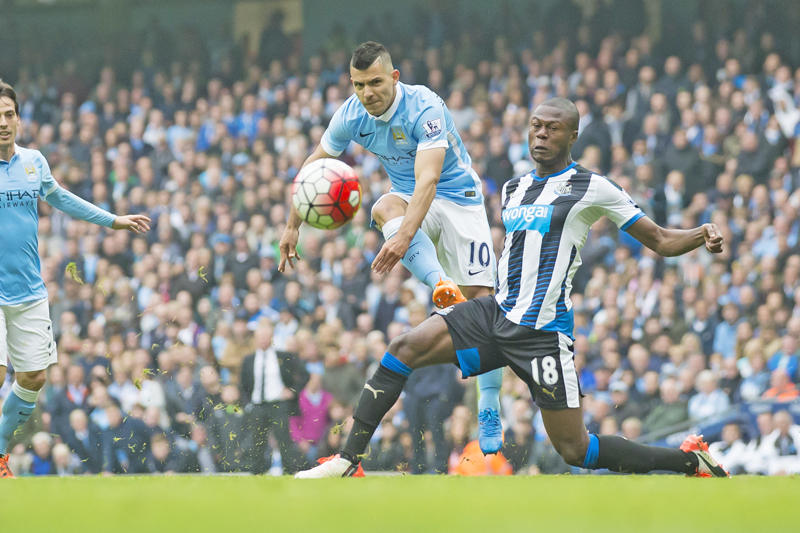 Manchester City's Sergio Aguero (left) scores past Newcastleu0092s Chancel Mbemba during their English Premier League match at the Etihad Stadium in Manchester on Saturday. Photo: AP