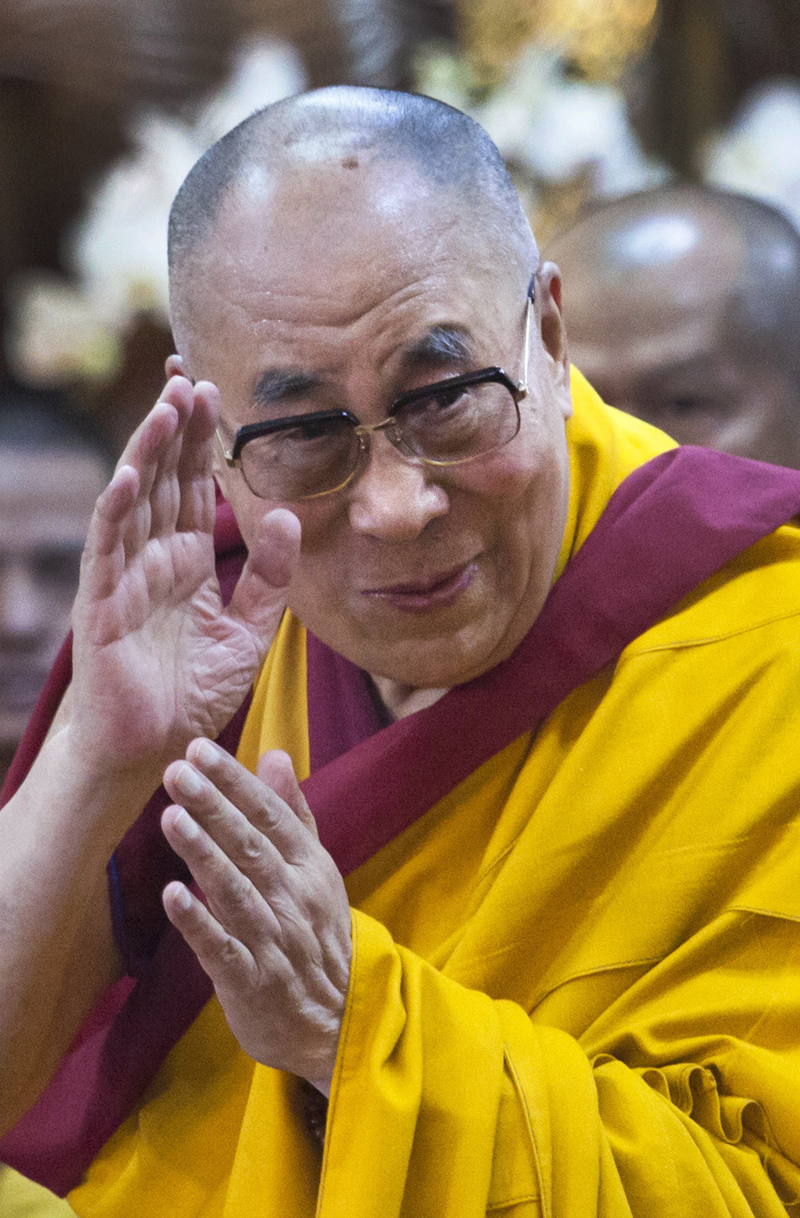 FILE - In this Sept. 7, 2015 file photo, Tibetan spiritual leader the Dalai Lama greets devotees as he arrives at the Tsuglakhang temple in Dharmsala, India. The University of Colorado says it was informed Friday, Sept. 25, 2015 that the Dalai Lama has canceled U.S. appearances next month following a checkup at Minnesota's Mayo Clinic. The school said doctors advised the 80-year-old holy leader to rest and that he would return to India. (AP Photo/Ashwini Bhatia, File)
