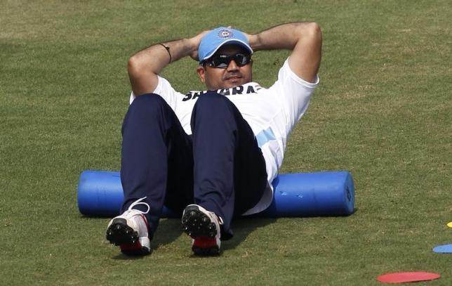 Virender Sehwag stretches during a practice session ahead of their first one-day international cricket match against the West Indies in Cuttack November 28, 2011.  REUTERS/Rupak De Chowdhuri/Files