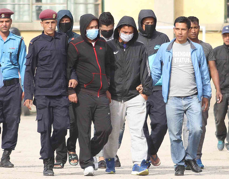 Five football players, masked and handcuffed, brought out of the Metropolitan Police Crime Division office after their arrest for match-fixing, in Teku of Kathmandu on Thursday, October 15, 2015. Photo: Udipt Singh Chhetry