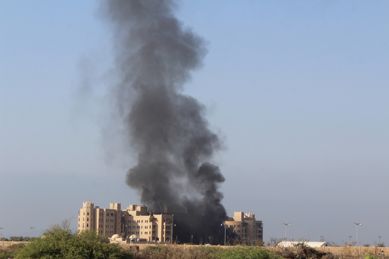Smoke rises following an explosion that hit Hotel al-Qasr where Cabinet members and other government officials are staying, in the southern port city of Aden, Yemen, Tuesday, Oct. 6, 2015. Security officials, who work for Yemen's internationally recognized government said three explosions have hit Aden and there are casualties in Tuesday's explosions but they had no specifics or details. (AP Photo/Wael Qubady)