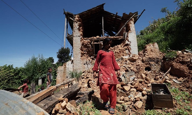 Residents of Barkobot, in Sindhupalchowk district, Nepal, walk through the remains of their earthquake-devastated village. Photograph: Pete Pattisson 