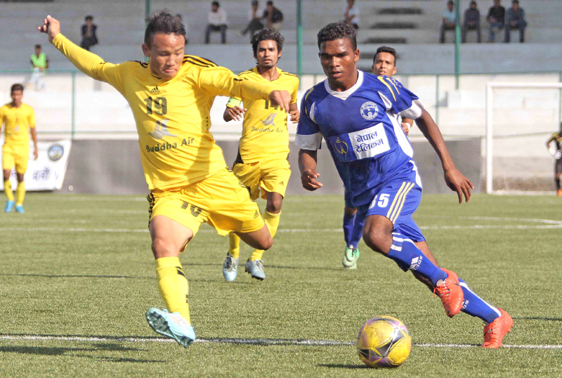 Nishan Limbu of Morang FC vies for the ball with Santosh Hemroon of Nepal Police Club during their Red Bull National League match at the ANFA Complex grounds in Lalitpur on Tuesday. Photo: Udipt Singh Chhetry/ THT