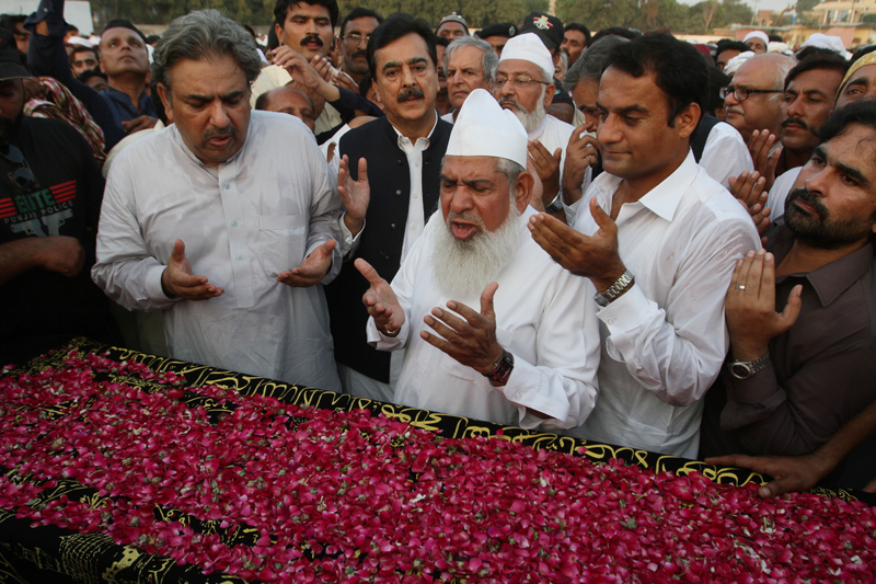 Pakistan's former Prime Minister Yousuf Raza Gilani, center in black, prays for his nephew who died last month in a stampede during the hajj pilgrimage in Saudi Arabia, during a funeral prayer in Multan, Pakistan, Monday, Oct. 5, 2015. Saudi authorities have said the disaster in Mina happened as two waves of pilgrims converged on a narrow road, causing hundreds of people to suffocate or be trampled to death. (AP Photo/Asim Tanveer)