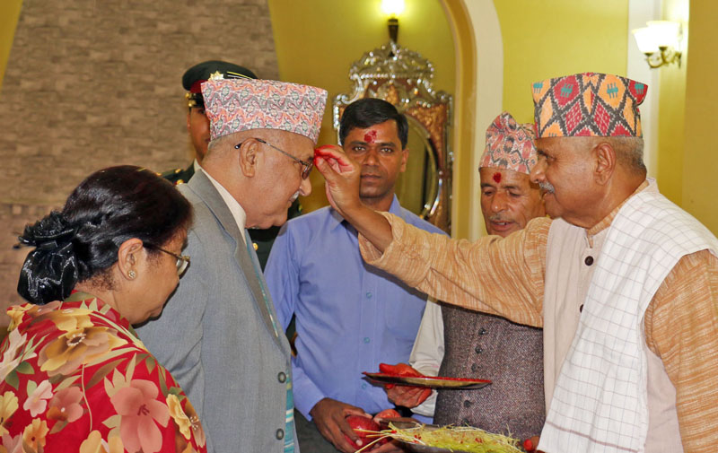 President Dr Ram Baran Yadav offfering Dashain Tika to Prime Minister KP Sharma Oli at Sheetal Niwas. Seen in the picture is PM Oli's wife Radhika Shakya also. Photo: RSS