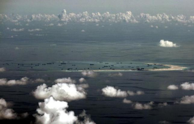 An aerial photo taken though a glass window of a Philippine military plane shows the alleged on-going land reclamation by China on mischief reef in the Spratly Islands in the South China Sea, west of Palawan, Philippines, May 11, 2015. REUTERS/Ritchie B. Tongo/Pool/Files