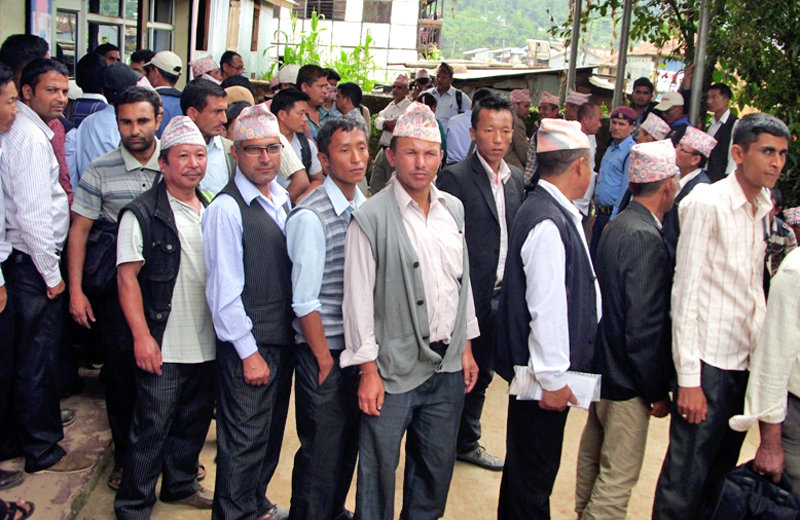 Teachers lining up to withdraw their salaries after the Education Office sent the amount at Nepal Bank Limited of Phidim, in Panchthar, on Monday. Photo: THT