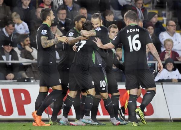 Football - Swansea City v Stoke City - Barclays Premier League - Liberty Stadium - 19/10/15nStoke's Bojan Krkic celebrates with team mates after scoring their first goal from the penalty spotnReuters / Rebecca Naden