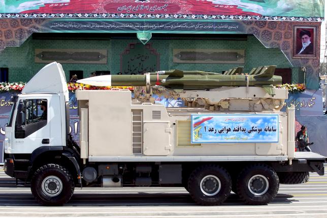 A military truck carrying a Raad missile drives past a picture of Iran's Supreme Leader Ayatollah Ali Khamenei (R) during a parade marking the anniversary of the Iran-Iraq war (1980-88), in Tehran September 22, 2015. REUTERS/Raheb Homavandi/TIMA