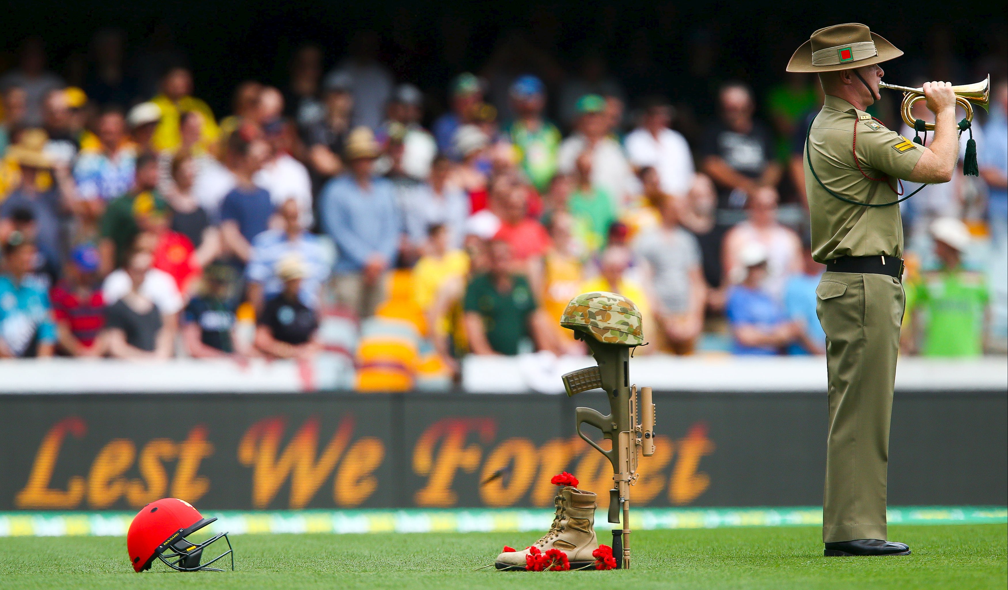 An Australian Army bugler plays the last post to commemorate the 100th anniversary of ANZAC and the death of Australian Test cricketer Phillip Hughes 12 months ago, before the first cricket test match between Australia and New Zealand in Brisbane November 5, 2015.  REUTERS/Patrick Hamilton    TPX IMAGES OF THE DAY