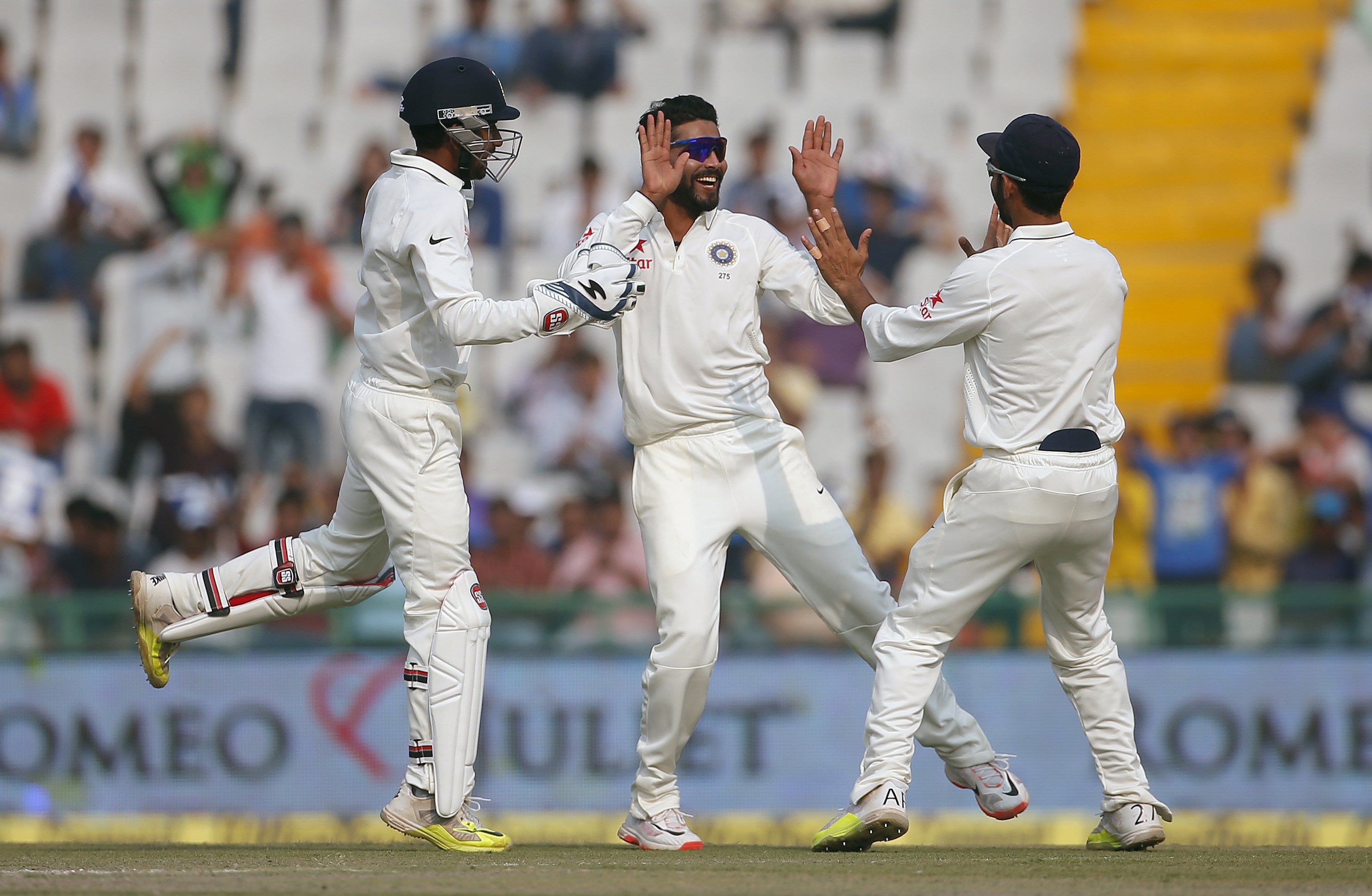 India's Ravindra Jadeja (centre), wicketkeeper Wriddhiman Saha and Ajinkya Rahane (right) celebrate the dismissal of South Africa's Dane Vilas (not pictured) during the third day of their first cricket test match, in Mohali, India, November 7, 2015. Photo: Reuters