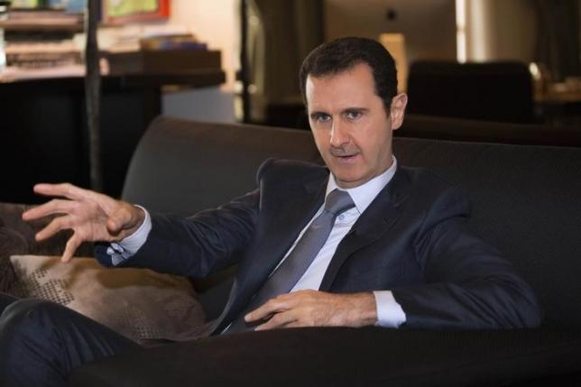 Syria's President Bashar al-Assad speaks during an interview with French magazine Paris Match,in Damascus,in this handout released by Syria's national news agency SANA on December 4, 2014. REUTERS/SANA/Handout/Files
