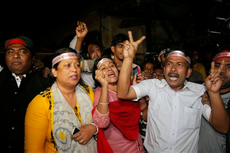 Bangladeshi activist shout slogans celebrating the execution of two war criminals Ali Ahsan Mohammad Mujahid of Jamaat-e-Islami and Salahuddin Quader Chowdhury of the Bangladesh Nationalist Party at the Central Jail in Dhaka, Bangladesh on Sunday, November 22, 2015. Photo: AP