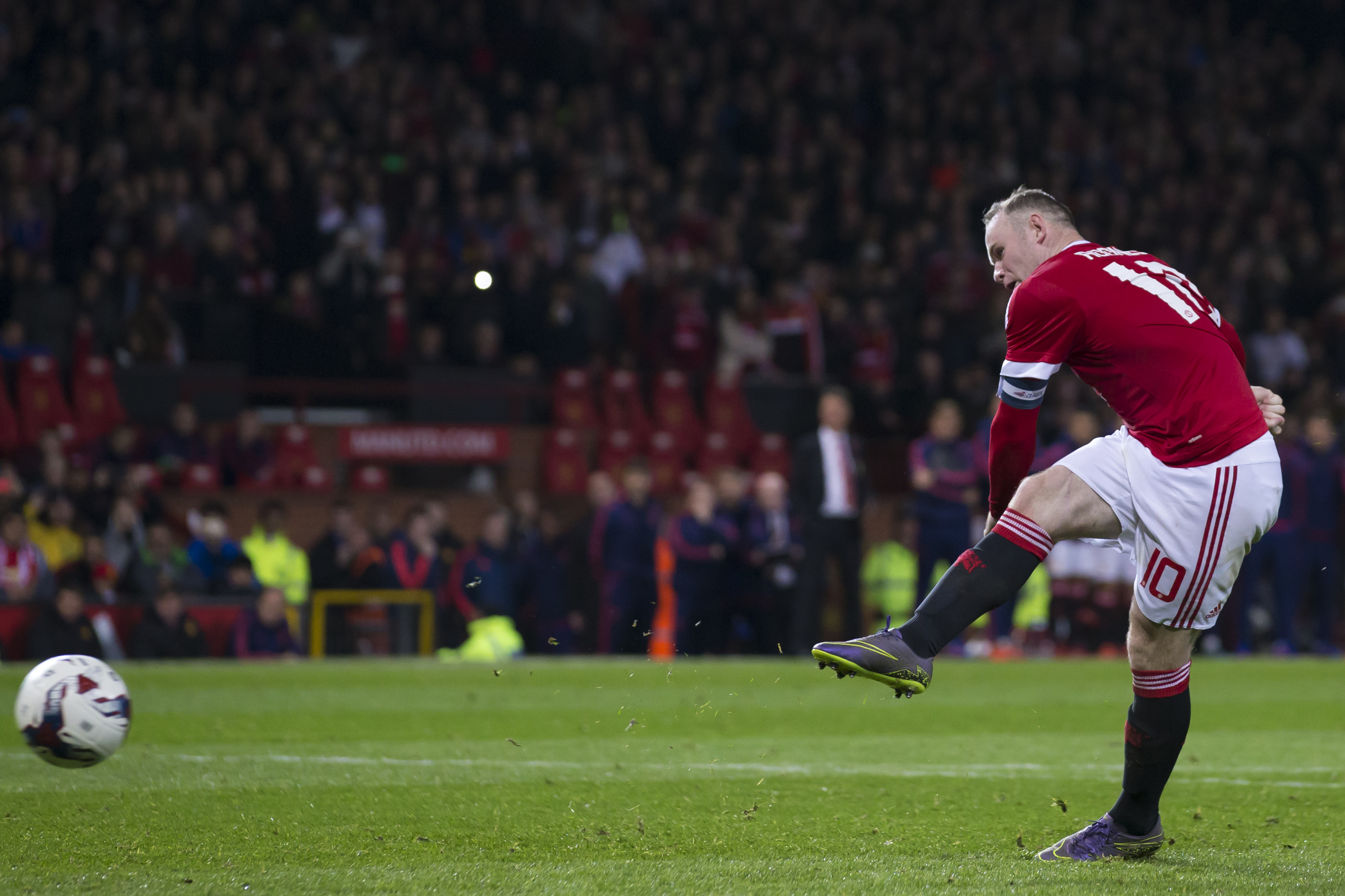 In this picture taken on Wednesday Oct. 28, 2015, Manchester United's Wayne Rooney takes a penalty during the English League Cup soccer match berween Manchester United and Middlesbrough at Old Trafford Stadium, Manchester, England. The Football Association is investigating claims that a laser was shone at Rooney as he took the penalty during the League Cup defeat by Middlesbrough. (AP Photo/Jon Super)