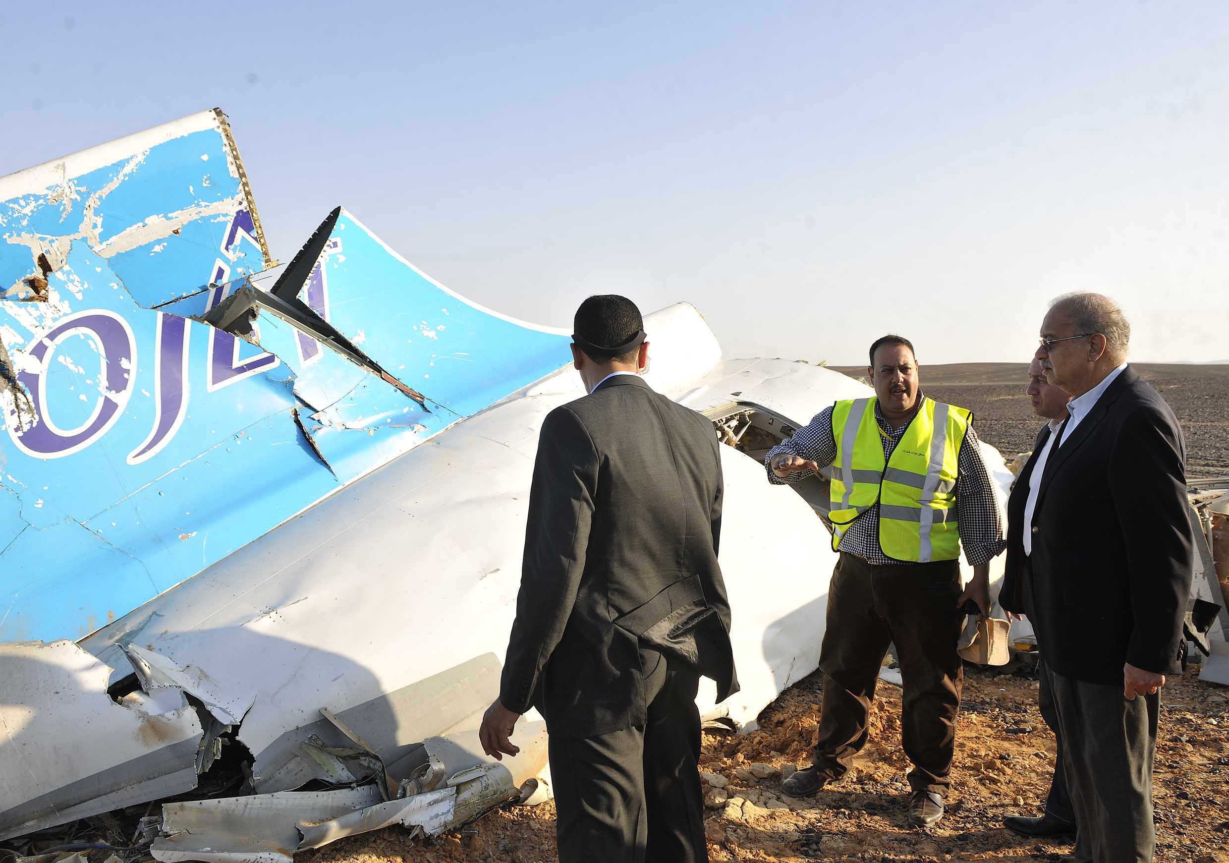 In this photo released by the Prime Minister's office, Sherif Ismail (right) looks at the remains of a crashed passenger jet in Hassana, Egypt on Saturday, October 31, 2015.  survivors. Photo: Egyptian Prime Minister's Office via AP