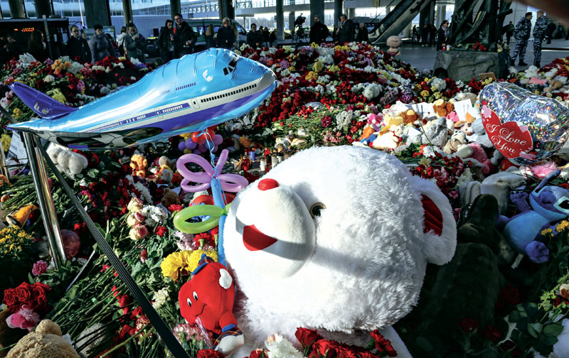 Floral tributes, toys and cadles laid ar an entrace of Pulkovo airport during a say of national mourning for the victims of a Russain airline plane crash, outside St Petersburg, on Tuesday. Photo: AP