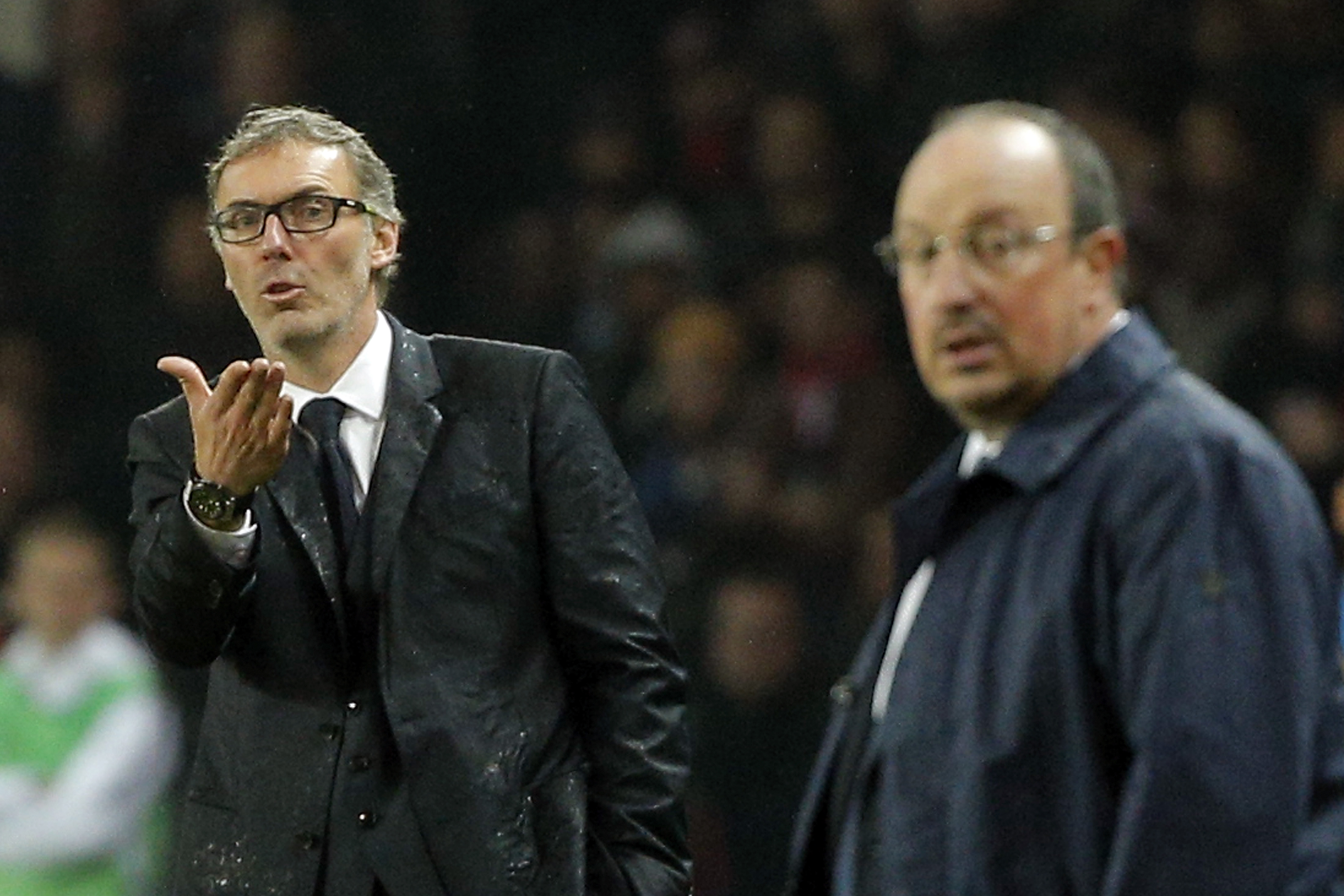 PSG headcoach Laurent Blanc, left, gestures as Real Madrid's headcoach Rafael Benitez looks on during the Champions League group A soccer match between Paris St Germain and Real Madrid at the Parc des Princes stadium in Paris, Wednesday, Oct. 21, 2015. (AP Photo/Thibault Camus)