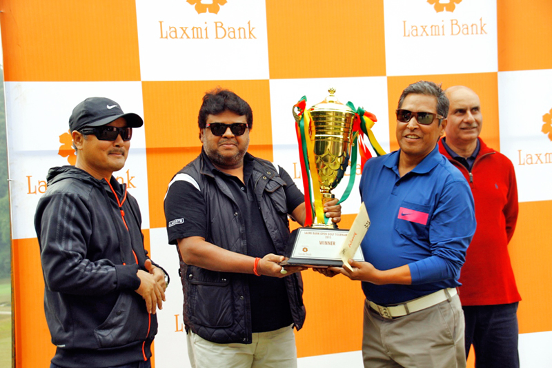 Robin Rana receives the Laxmi Bank Open Golf  trophy from the Banku2019s Chairman Rajendra Kumar Khetan (left) on Saturday.