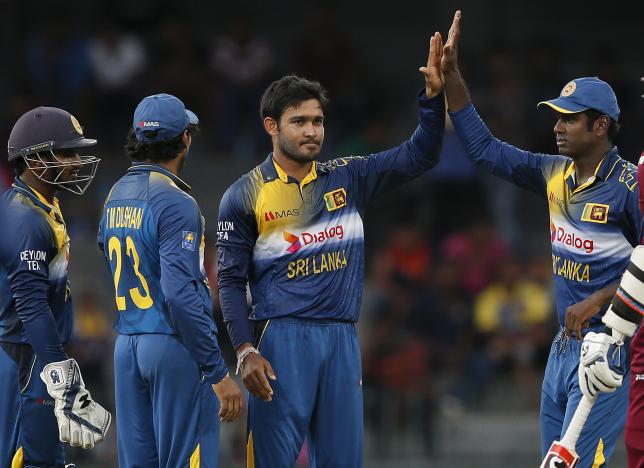Sri Lanka's Milinda Siriwardana (2nd R) celebrates with captain Angelo Mathews (R), Tillakaratne Dilshan (23) and Kusal Perera after taking the wicket of West Indies' Johnson Charles (not pictured) during their second One Day International cricket match in Colombo November 4, 2015. REUTERS/Dinuka Liyanawatte